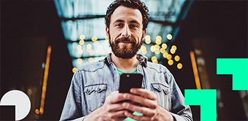 Mann mit Bart h&auml;lt ein Smartphone. Im Hintergrund sind Lichter zu sehen. Es gibt einen St&ouml;rer mit dem Text „Bis 31.05.“.