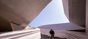 Ein Mann steigt eine moderne Beton-Treppe hinauf.