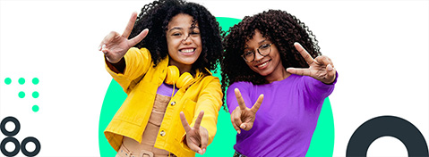 2 M&auml;dchen zeigen l&auml;chelnd das Peace-Zeichen.